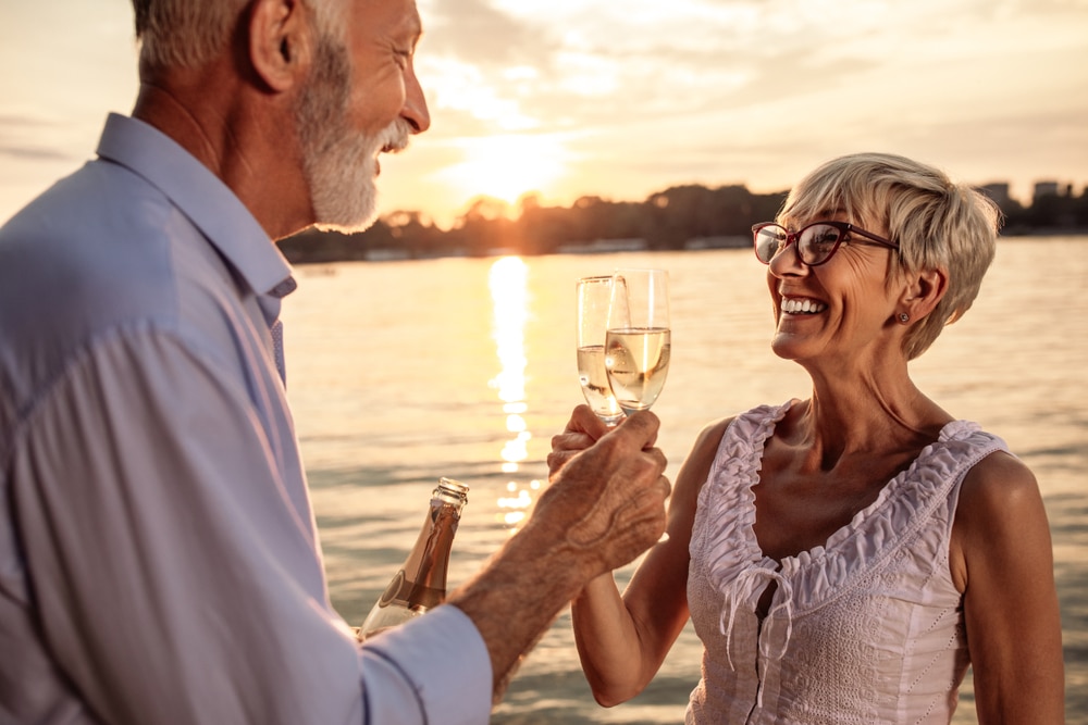 Things to do in McHenry, MD, happy couple enjoying a glass of wine near the Lake at our Deep Creek Lake Bed and Breakfast