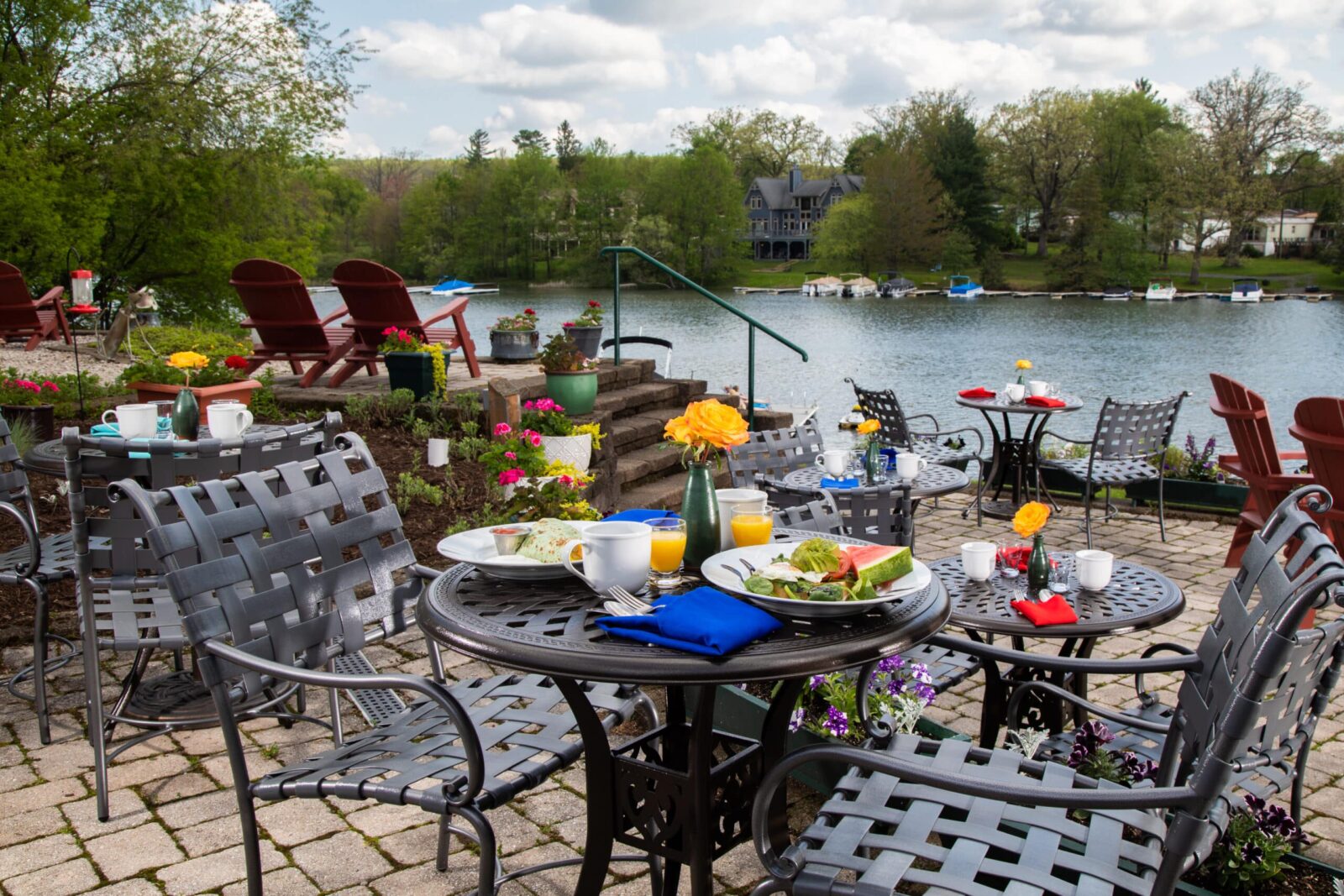 Outdoor tables set with breakfast at Lake Pointe Inn, view of Deep Creek Lake.